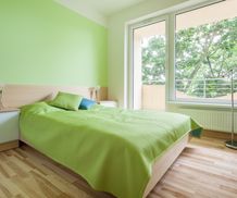 Horizontal interior of bedroom with green elements